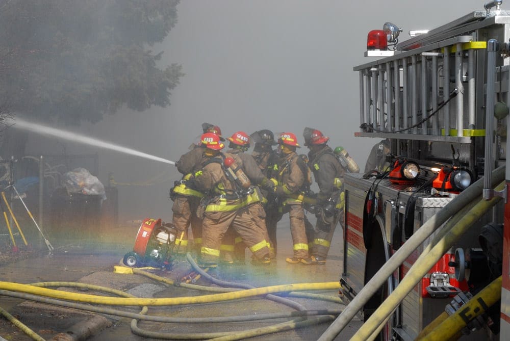 Stand with us to Stand with Them Firefighters putting water on fire